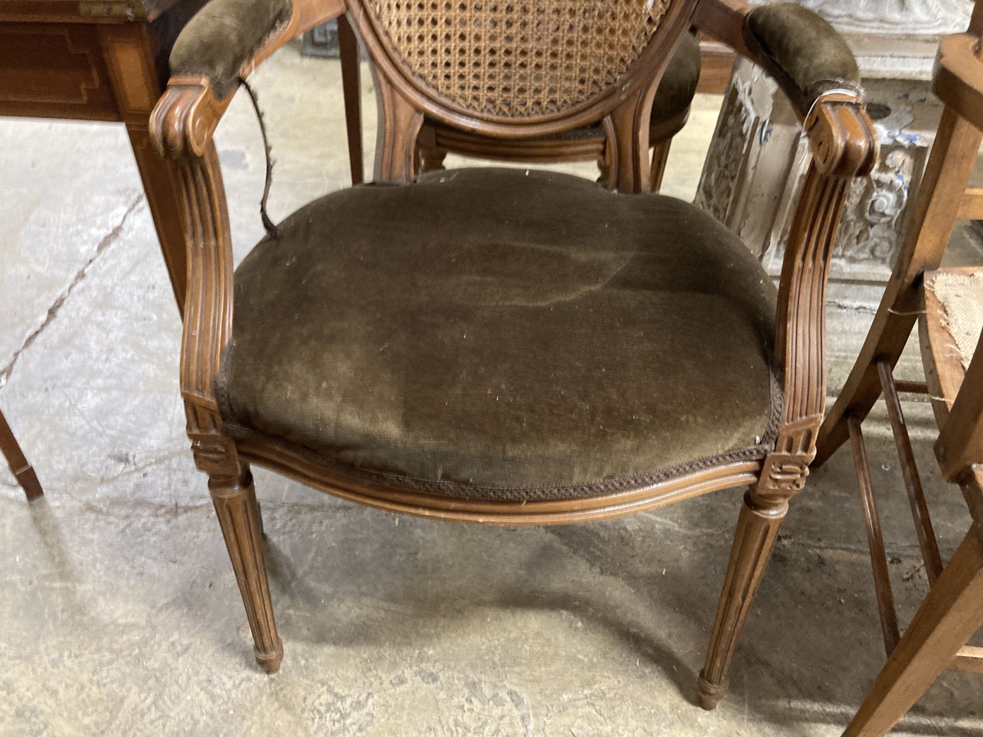 A pair of Louis XVI style caned back fauteuils